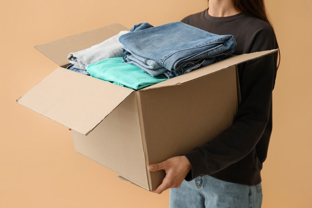 Mujer con caja de recogida de ropa